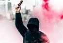 Warren, https://unsplash.com/photos/person-wearing-black-and-red-hoodie-holding-smoke-bomb-bh4LQHcOcxE